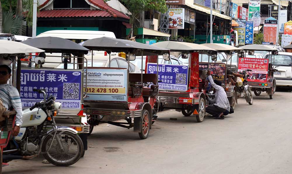 A row of tuk tuk drivers wait for customers. Sihanoukville was once a popular destination for tourists from all over the world, but the rise in Chinese investment has seen a decline in tourists from other countries. Photo: RFA