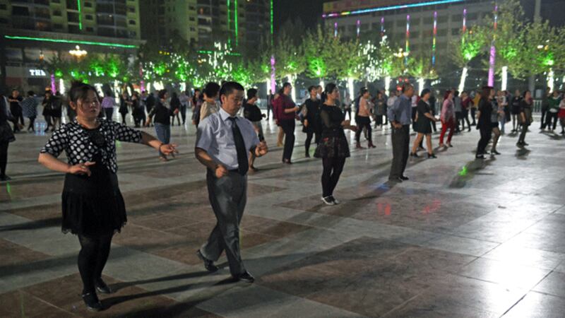 Han Chinese couples dance in a square in Hotan, northwestern China's Xinjiang region, in a file photo. Credit: AFP