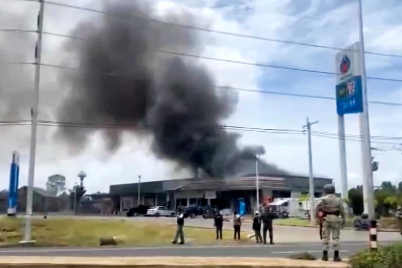 In this image made from video, smoke rises from a convenience store at a gas station, amid the clashes between Thailand and Cambodia, in Kantharalak district, Sisaket province, Thailand, July 24, 2025.