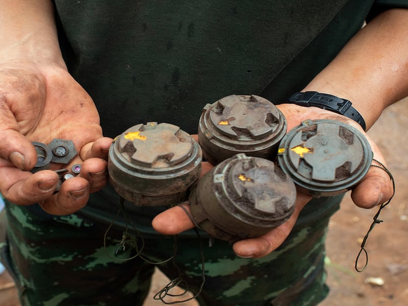 A member of the anti-junta Karenni Nationalities Defence Force holds landmines planted by the Myanmar military and removed during demining operations near Pekon township, July 11, 2023.