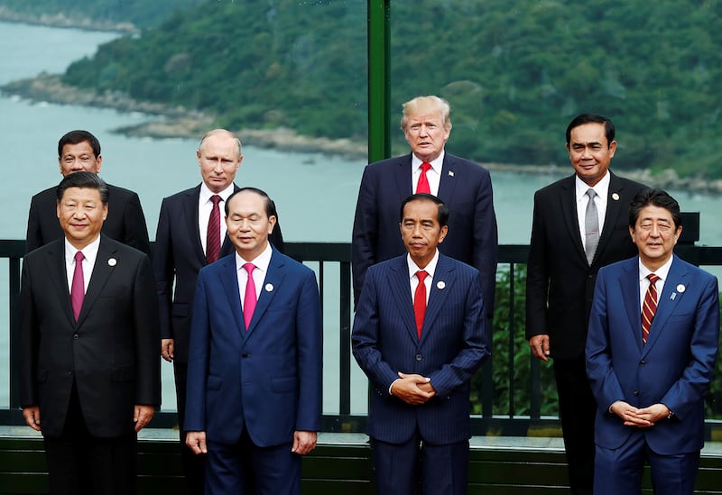Then-U.S. President Donald Trump (back row, 2nd from R) attends a photo session with Russian President Vladimir Putin (back row, 2nd from L), Chinese President Xi Jinping (front row, L), and other Asian leaders at the Asia-Pacific Economic Cooperation Summit in Danang, Vietnam, Nov. 11, 2017.