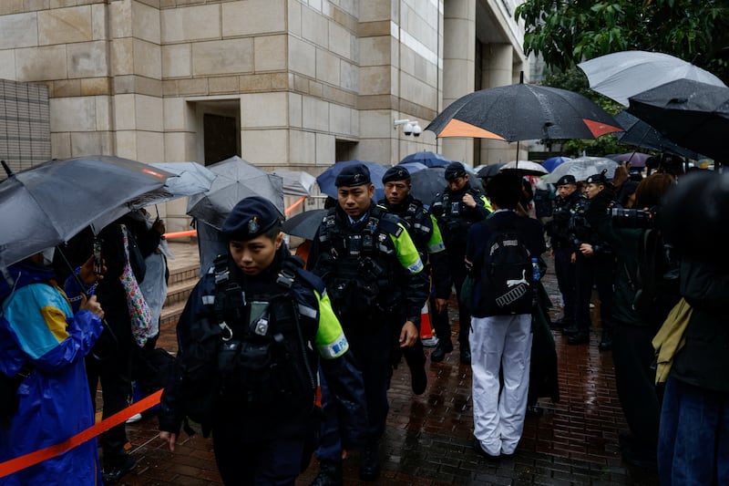 Police patrol outside the West Kowloon Magistrates' Courts building as Jimmy Lai, the founder of the now-defunct pro-democracy newspaper Apple Daily, takes the witness stand for the first time in the national security collusion trial, in Hong Kong, China, Nov. 20, 2024.
